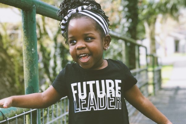 image of little girl in black tee with "future leader" printed on front